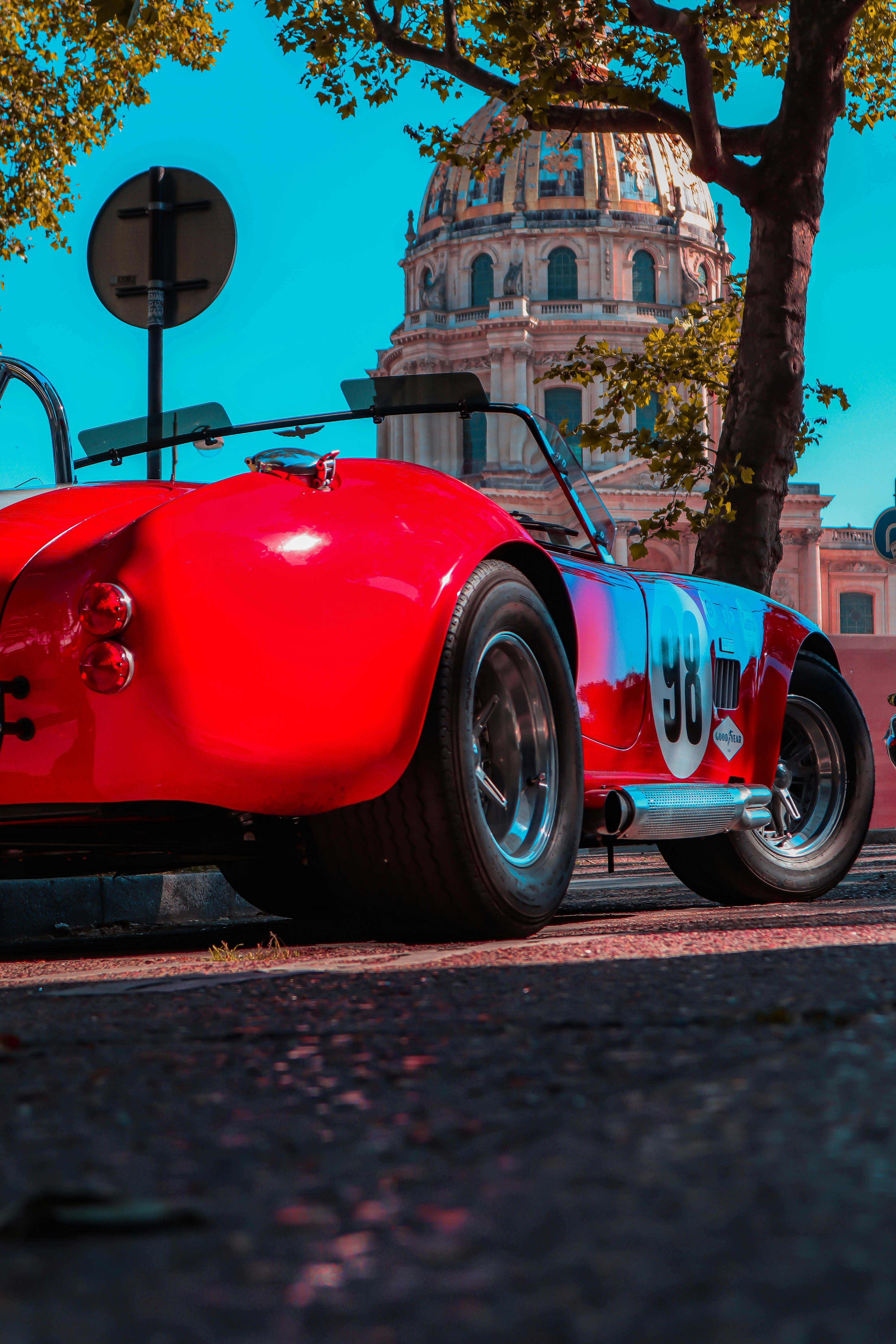 red ferrari car parked on sidewalk during daytime